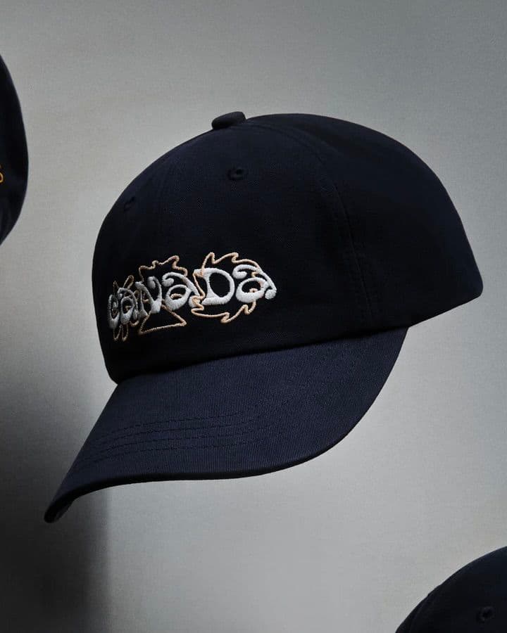Black baseball cap with white embroidered Canada logo.